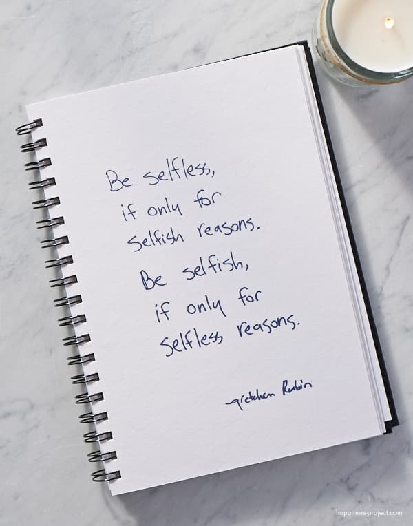 White notebook with "Be Selfless, If Only for Selfish Reasons; Selfish, If Only for Selfless Reasons" written.