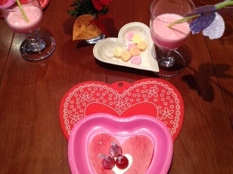 Photo of Valentine's Day breakfast on red and pink heart plates.