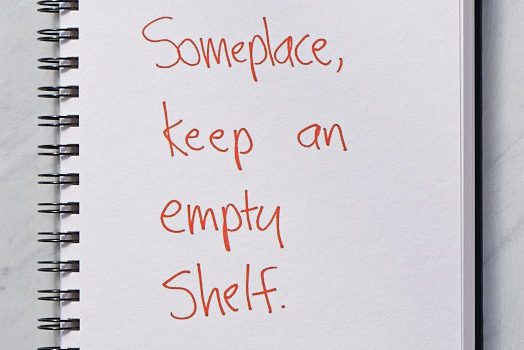 White notebook paper with "someplace, keep an empty shelf" written on it.