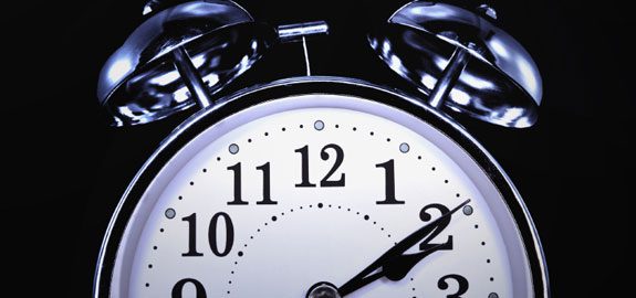 Close up of an old alarm clock set to 2 am.