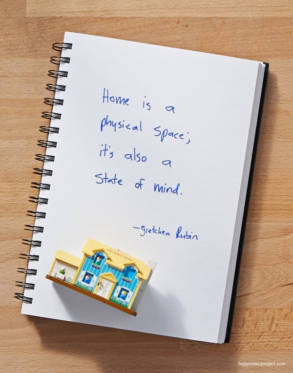 Notebook with handwritten text saying "Home is a physical space, it's also a state of mind".