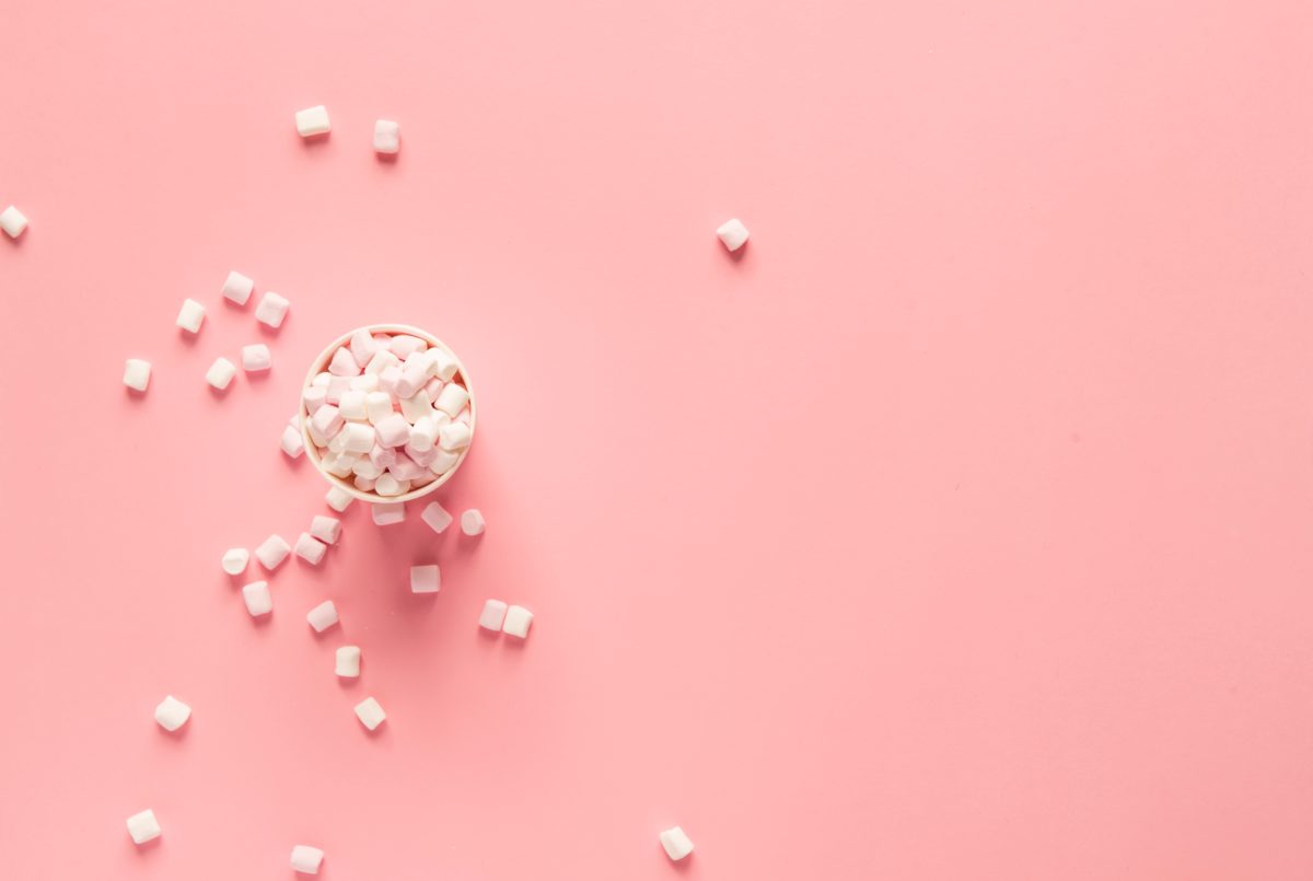 marshmallows in a bowl on pink background