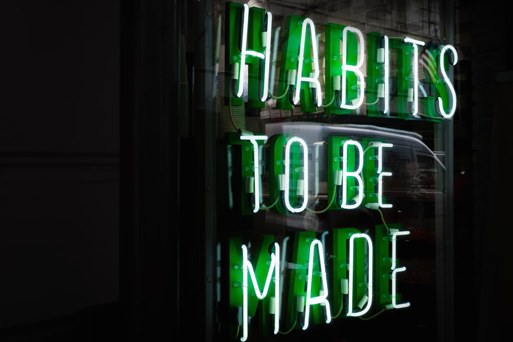 Neon sign saying "Habits To Be Made"