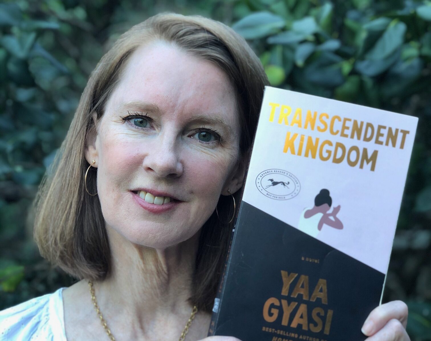 Gretchen holding the book Transcendent Kingdom by Yaa Gyasi