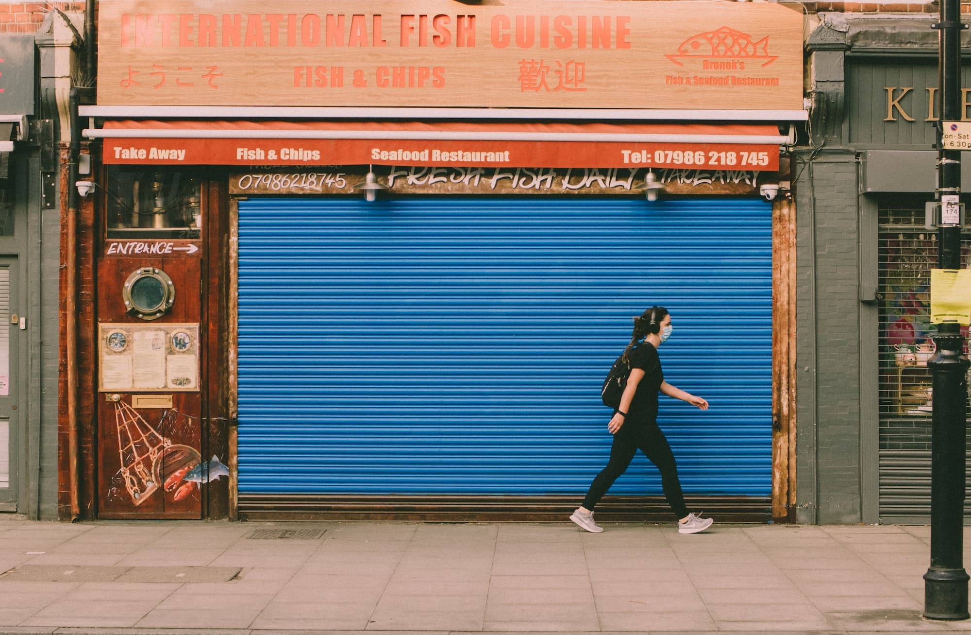 Person walking in front of a closed store