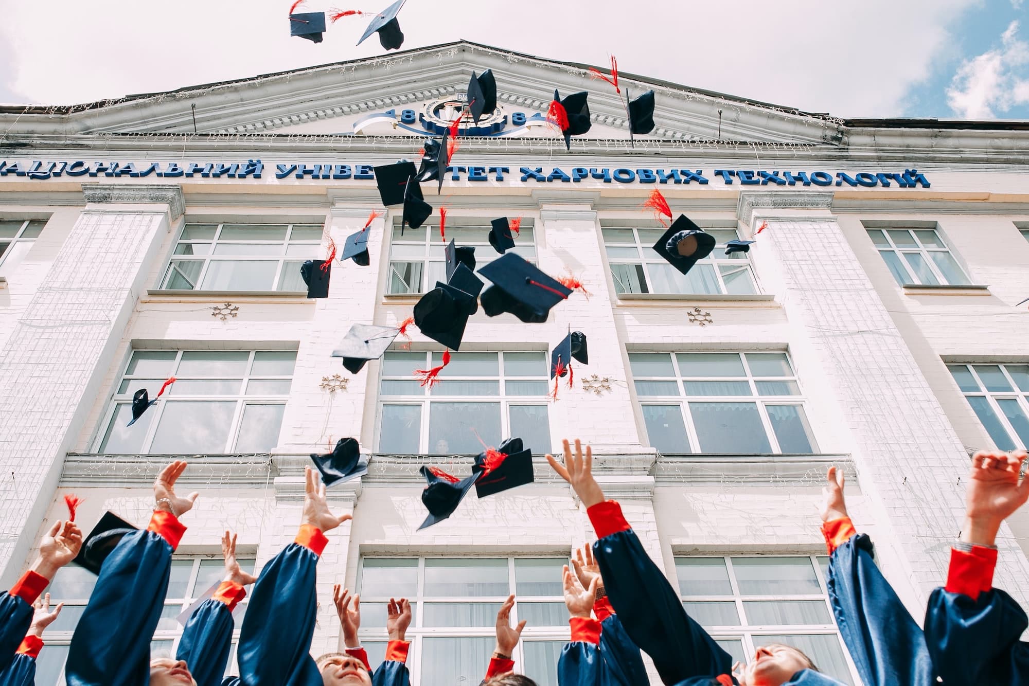 graduation hats thrown in the air
