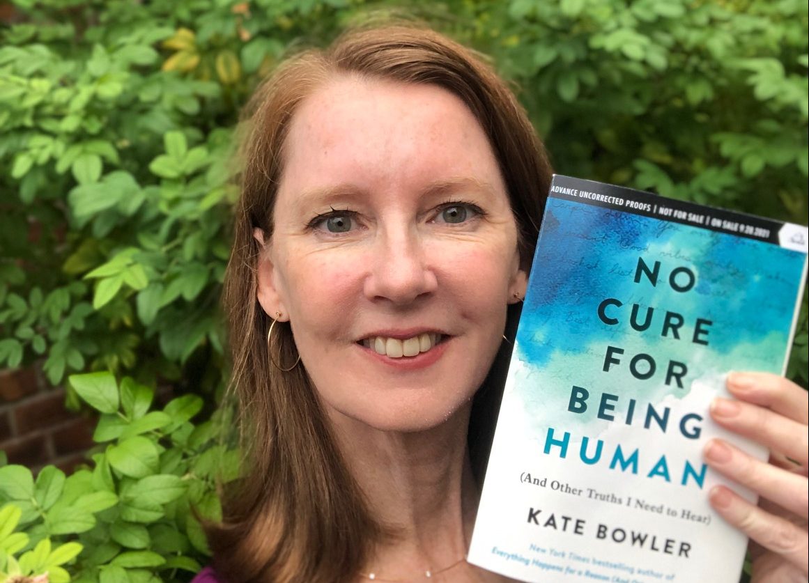Gretchen holding the book No cure for being human by Kate Bowler