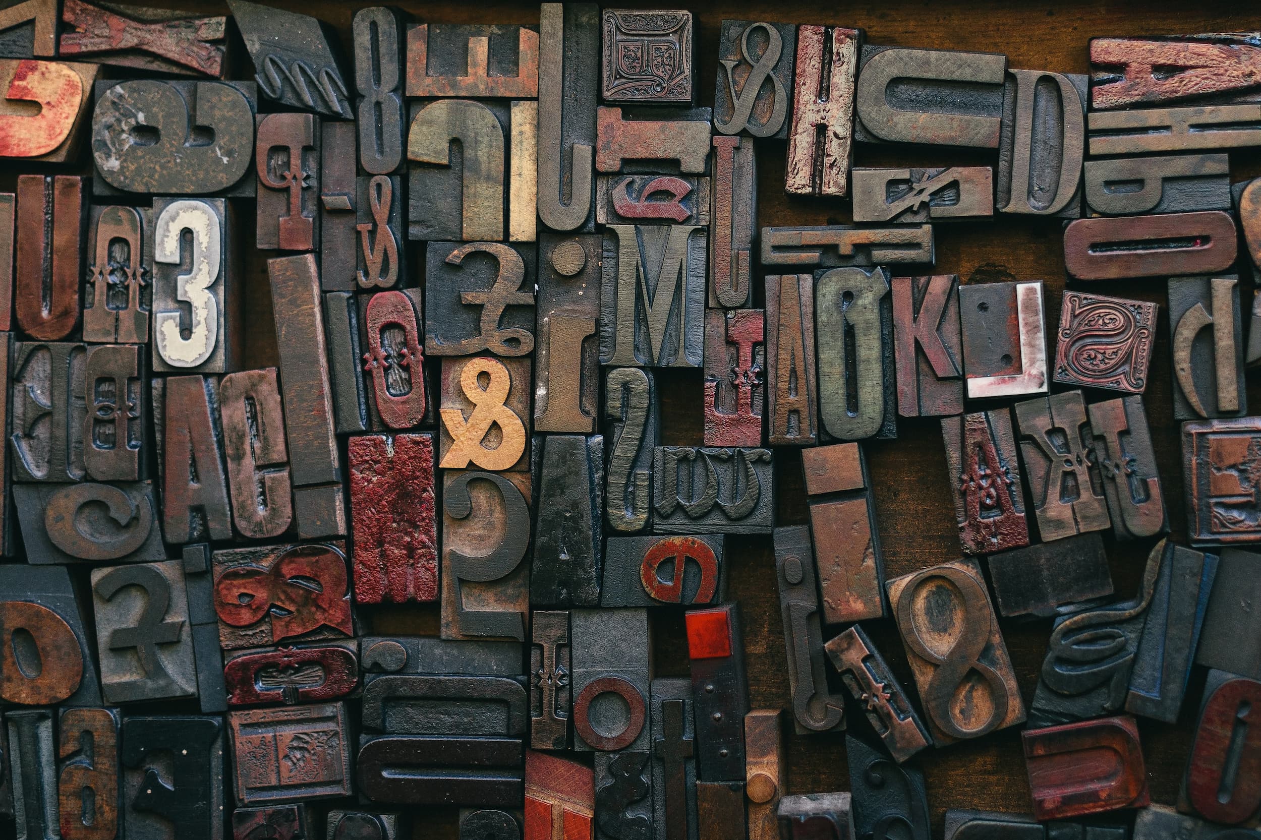 Array of rustic, used stamps arranged on rusted surface