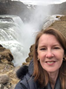 Selfie of Gretchen Rubin in front of icelandic waterfall