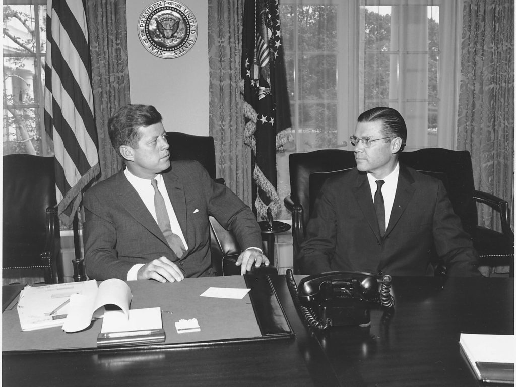 Photo of JFK having a meeting