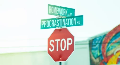 Stop Sign with Procrastination Way street sign