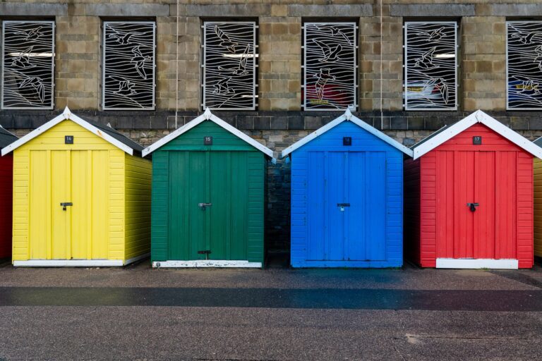 Photo of four primary colored beach huts
