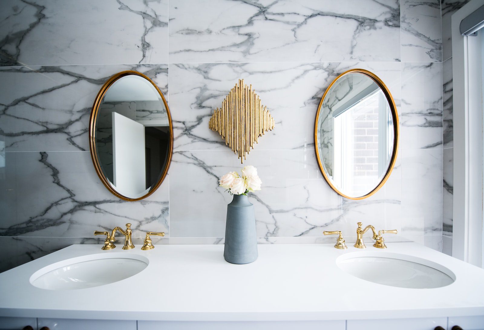 Bathroom with marble walls and white ceramic sink