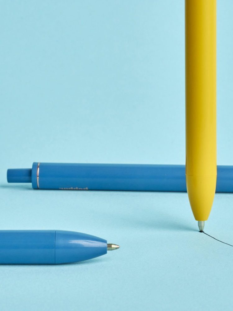 Blue and yellow pens on blue background