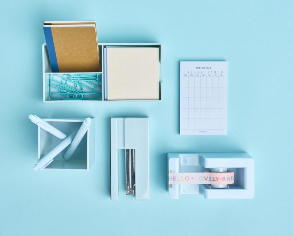 Blue office supplies on blue background