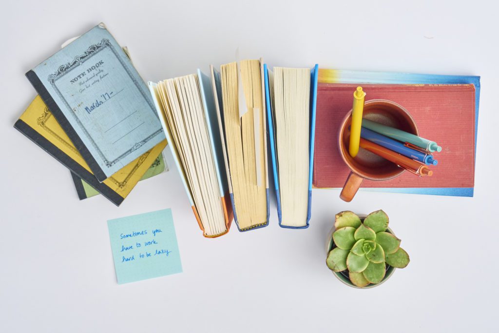 Books and notebooks on a tabletop