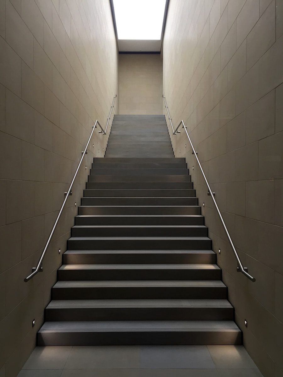 gray concrete stair with gray steel handle