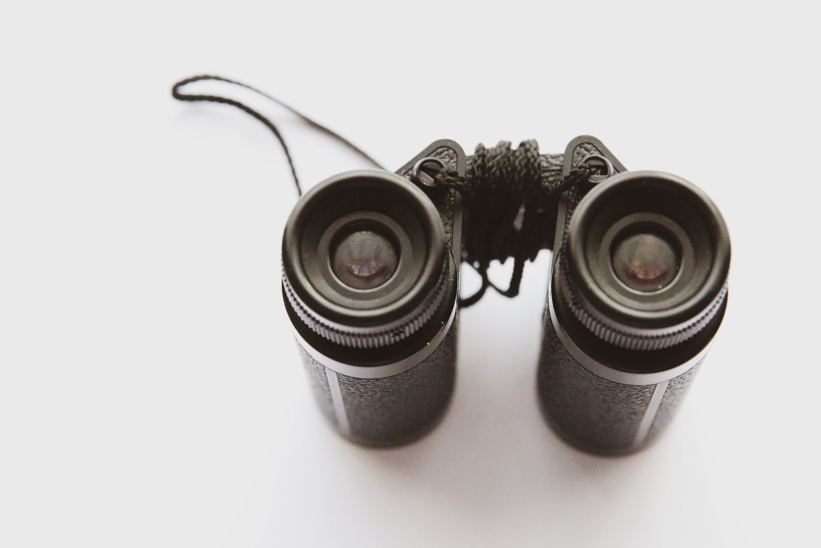 black binoculars on white surface