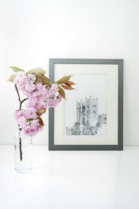 rectangular gray wooden photo frame beside pink flower
