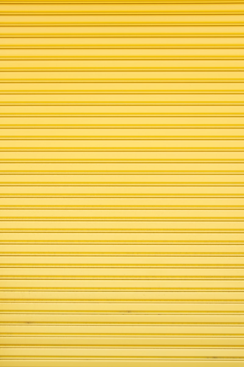 a yellow garage door that is closed