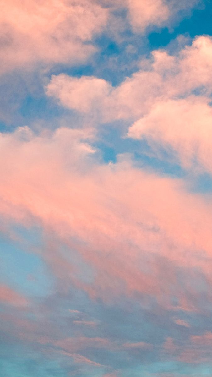 A plane flying in the sky with clouds