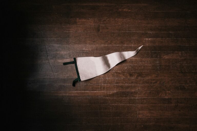 a crumpled white flag on a dark wooden floor