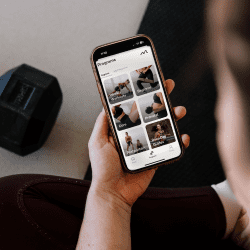 Woman holding a phone displaying the Moves app