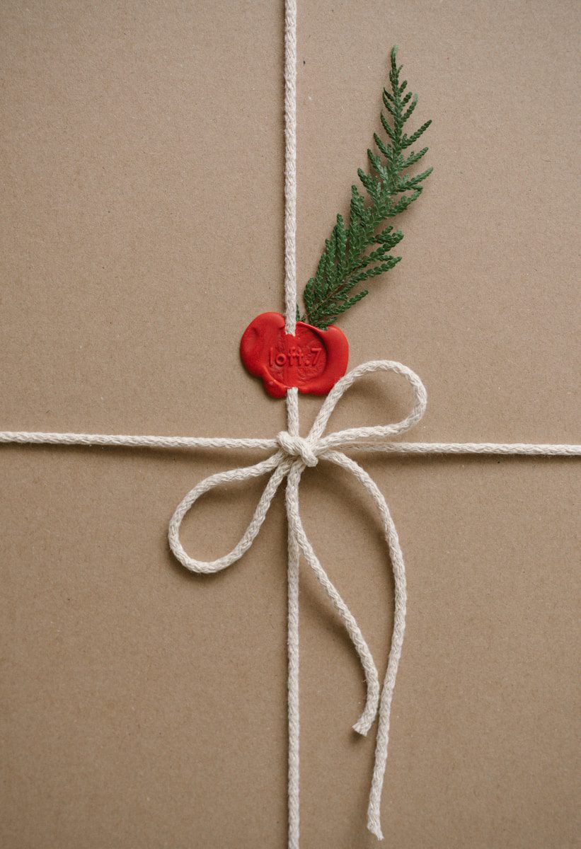 Brown gift box tied with white string and red seal