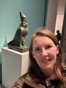 Gretchen posing in front of a small statue