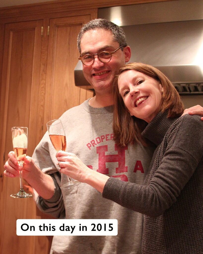 Gretchen and Jamie posing together with smiles and champagne