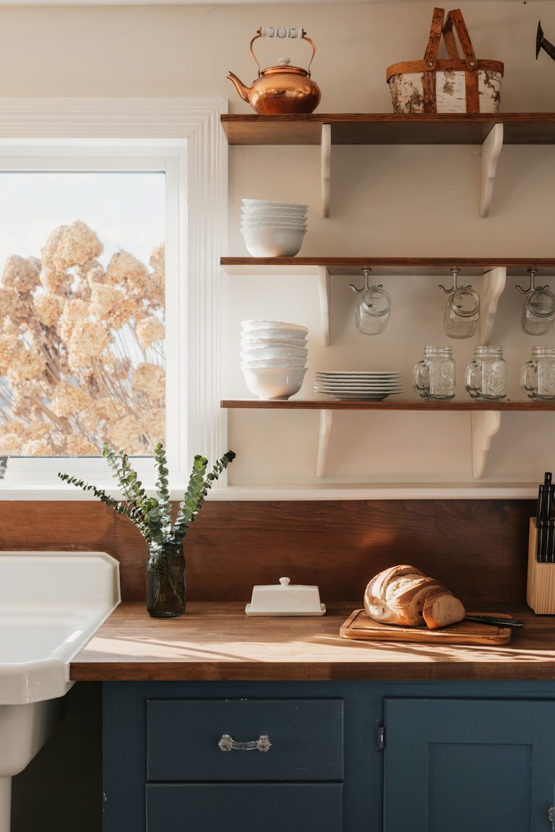Rustic kitchen counter with bread and dishes.