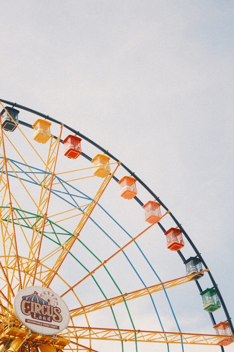 Colorful ferris wheel against a pale sky