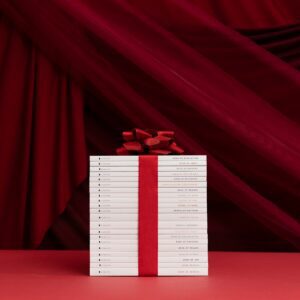 a red ribbon wrapped around a white piece of paper