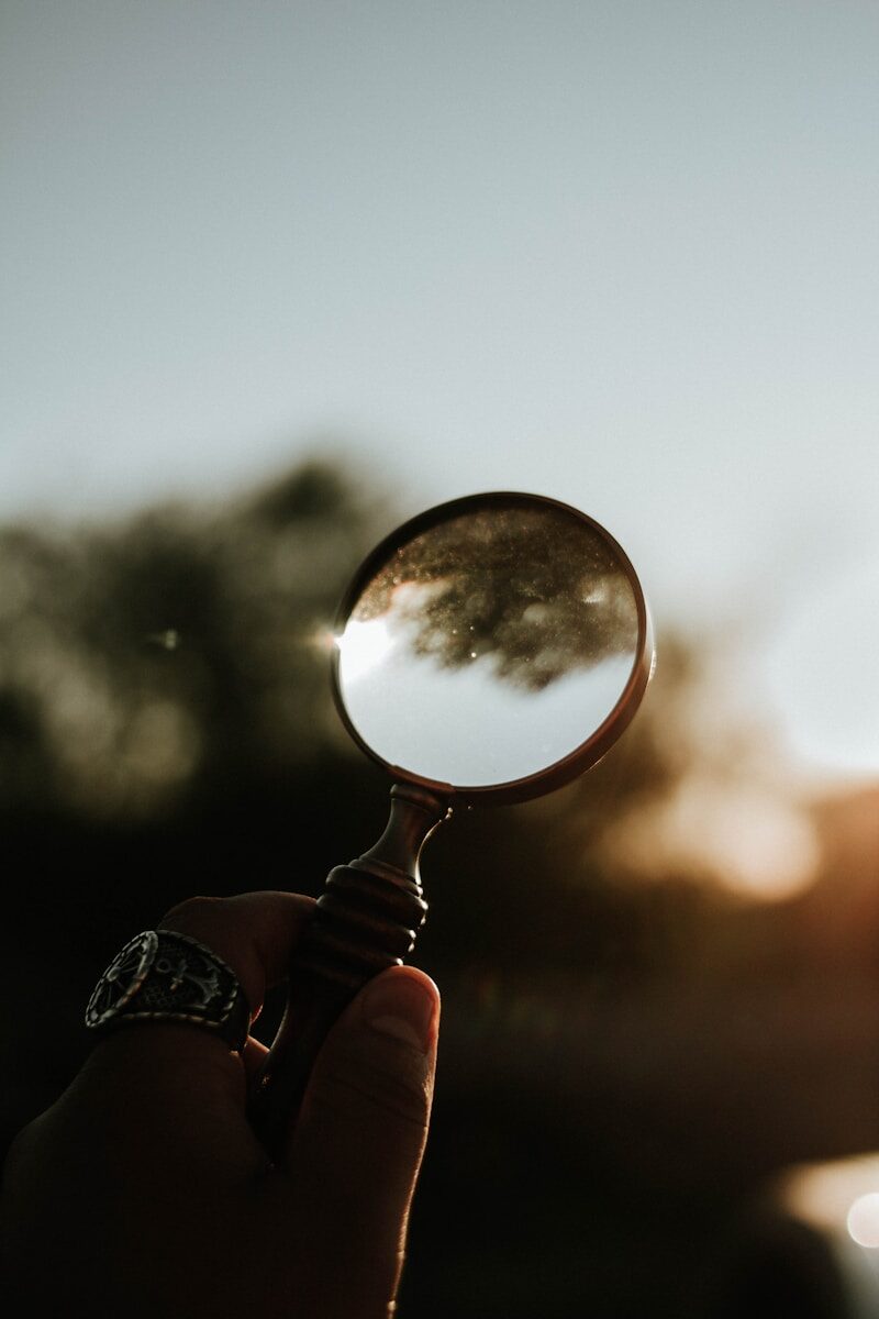 person holding magnifying glass