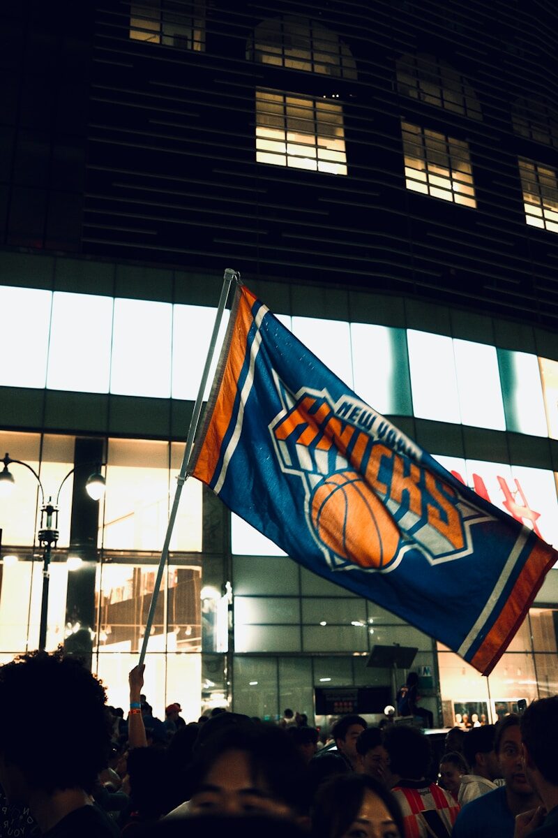 New york knicks flag waving in a crowd at night.