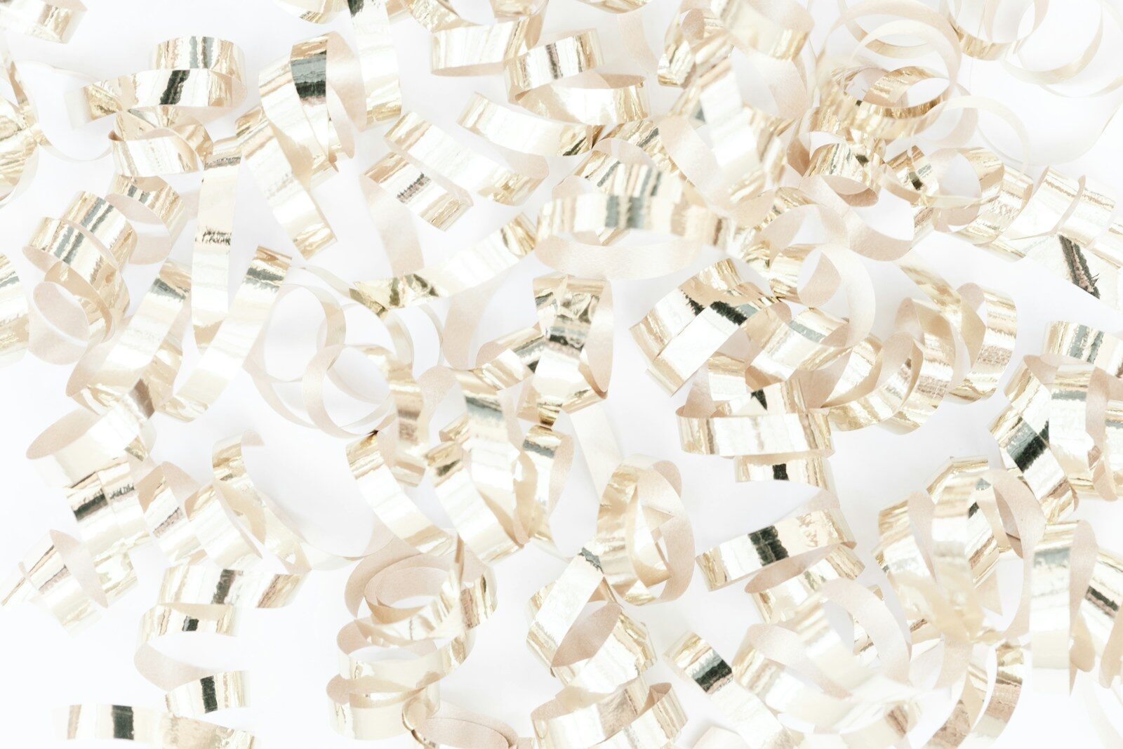 a pile of shiny ribbons on a white background