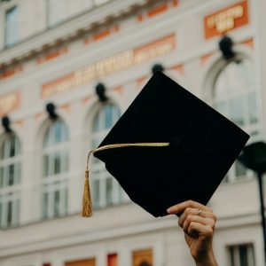 person holding black academic hat