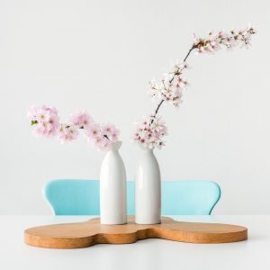 Clean dining table with vased full of cherry blossom branches